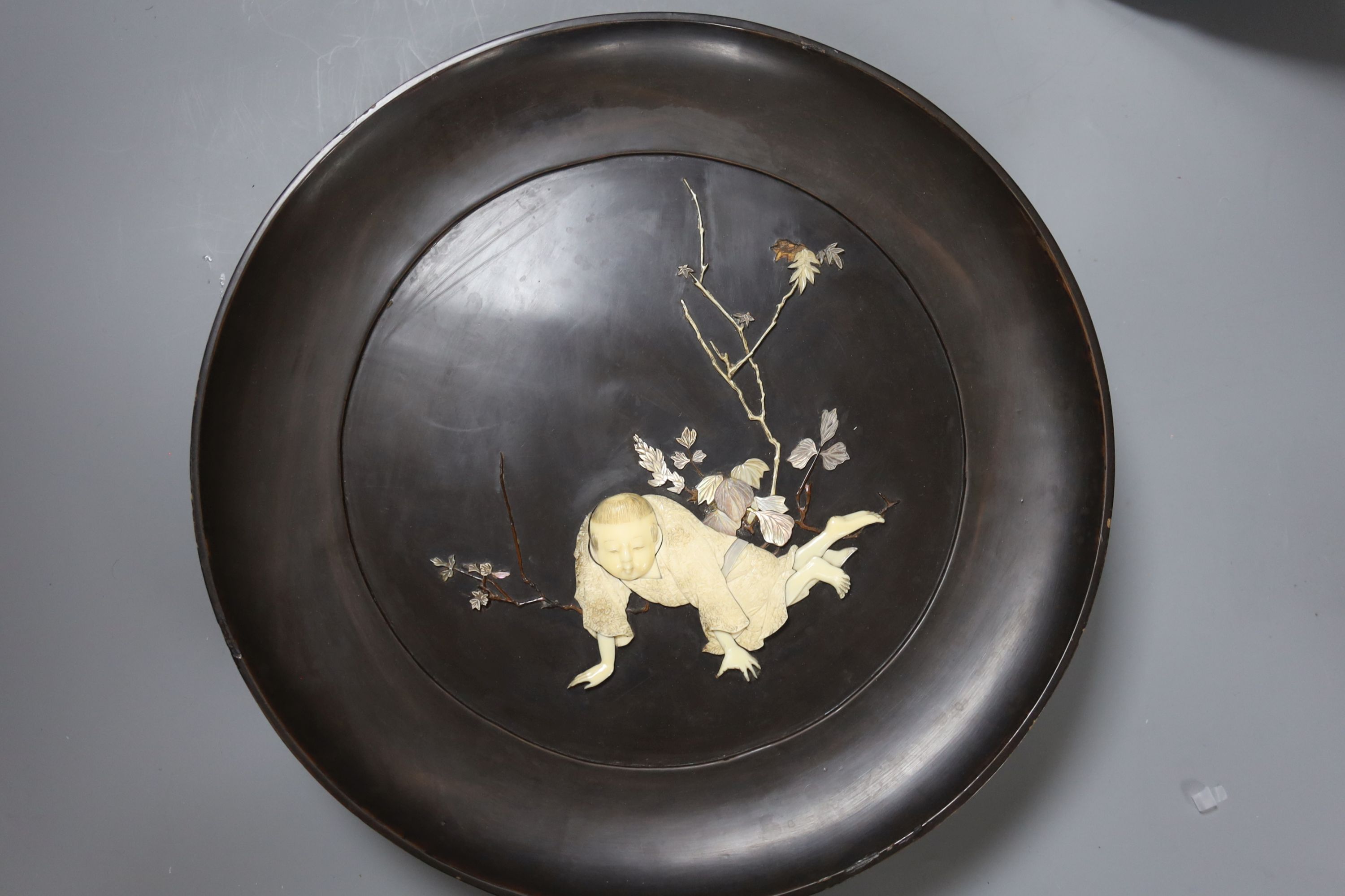 A Japanese Arita dish together with a similar ivory and mother of pearl mounted lacquer dish, diameter 30cm